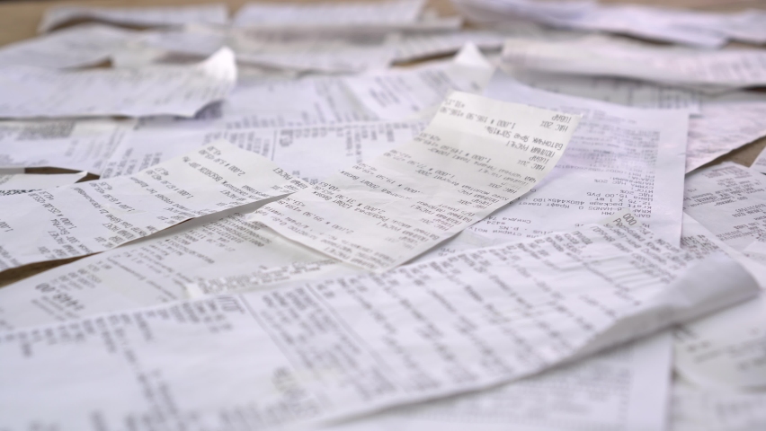 Lots of paper receipts from purchase. Expenses, spending, shopping, unconscious consumption. Compulsive buying disorder. Covid-19 global economy financial crisis concept Royalty-Free Stock Footage #1061169763