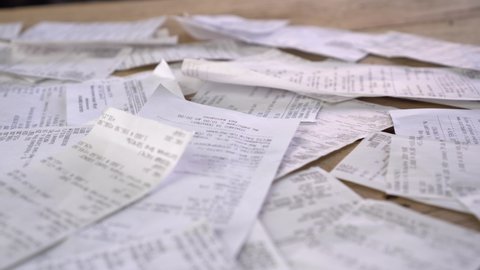 Lots of paper receipts from purchase. Expenses, spending, shopping, unconscious consumption. Compulsive buying disorder. Covid-19 global economy financial crisis concept