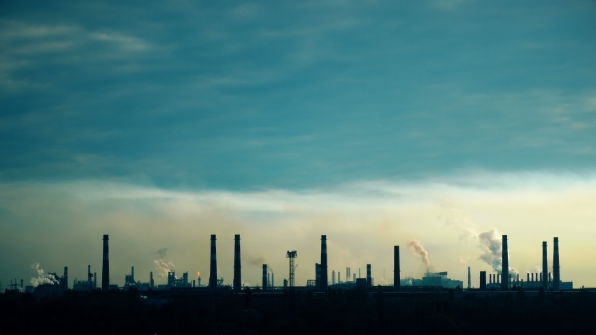 Industrial factory against the blue sky. Mining background. Metallurgical industrial factory. Poisoned air. Epic pollution of nature. Toxic substances. | Shutterstock HD Video #1061171026