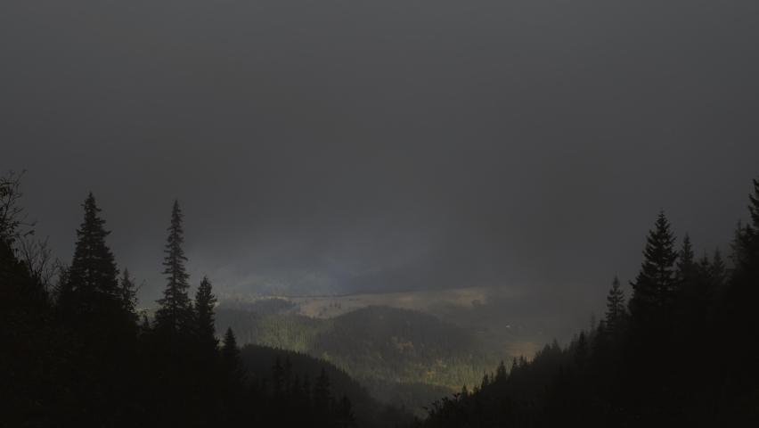 Rainbow after the rain over the forest. time lapse. Mountain landscape, Rainbow in the Mountains and Dramatic Clouds