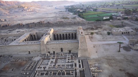 Aerial view Medinet Habu temple from hot air balloon with Valley of the kings village background Luxor Egypt