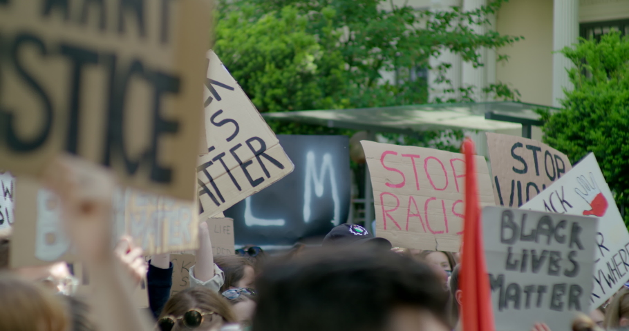 2020 year Issues: Black Lives Matter Protest and Coronavirus Pandemic. Crowds of People with Signes about Justice, Racism and COVID-19. 4K Background Slow Motion Shot Royalty-Free Stock Footage #1061184871
