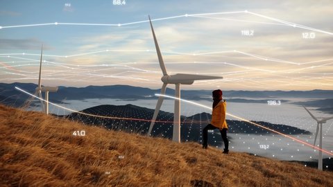 Epic shot of a woman hiking on the edge of the mountain against landscape with wind turbine power station on background. Concept of: environmental engineering, renewable energy and love for nature