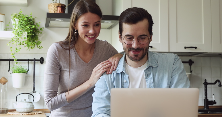 Overjoyed young couple looking at laptop screen, celebrating getting good news notification, banking loan approval, last mortgage payment. Happy spouses supporting favorite team, watching sport match. Royalty-Free Stock Footage #1061186365