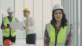Business concept. Young Asian businesswoman giving an interview in the office and backside employee discussing. 4k Resolution.
