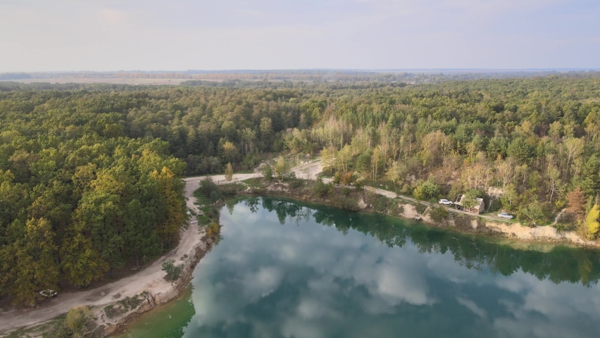 Blue lake in the forest.
View from above 4K Video