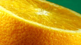 4k Macro shot of navel orange fruit and rotate.Close up fresh citrus orange green background Slow motion 4K UHD video.