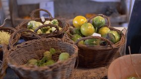 Close up tomatoes in wooden basket at the farmer's market. Panning. Video 4K