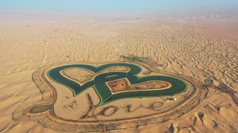 Aerial view of heart shaped love lake in the middle of desert; man made lake in Dubai desert