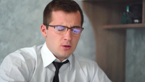businessman man with glasses sneezes