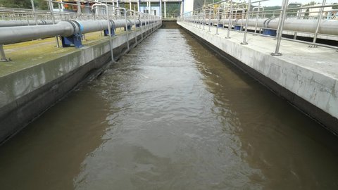 Sewage water dispersion is aerated to separate heavier sludges at bottom. The first sedimentation step in wastewater treatment plant. 