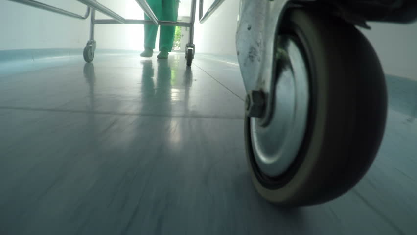 Low level close up of medical professional bed wheel moving on hallway  Royalty-Free Stock Footage #10612148