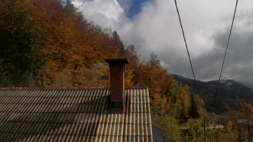 smoke coming from a chimney on a chilly  autumn day