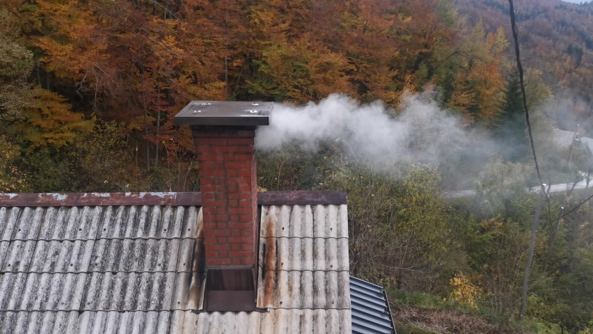 smoke coming from a chimney on a chilly  autumn day