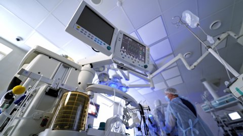 Medical equipment for saving patient's life. Work of artificial lung ventilation device under medical monitors in the operating room. View from below.