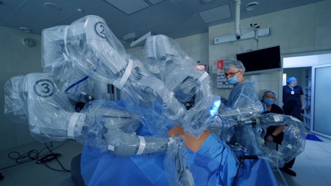 Robot with surgical arms in operating room. Modern surgery with robotic technology equipment in hospital. Minimally invasive surgical innovation.