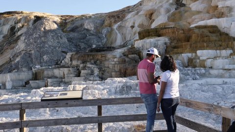 MAMMOTH, WYOMING_SEPT 29, 2020: Unidentifiable tourists view travertine terraces at Mammoth Hot Spring