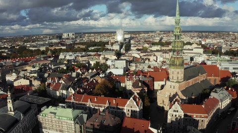 Aerial view of the St. Peter's Church and Domes Cathedral in Riga, Latvia at sunset. Beautiful colors of Riga old town from above. Amazing Latvia.