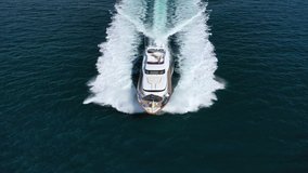 Aerial drone tracking video of luxury yacht cruising in deep blue Aegean sea, Greece