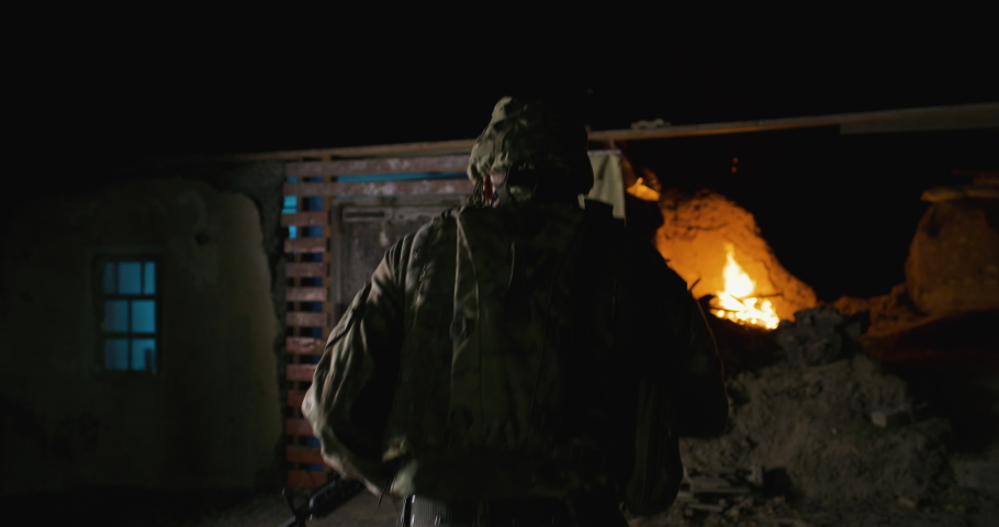 Tracking shot of armed soldier entering hidden cabin of secret intelligence post with flag of USA and reporting to man of higher rank