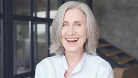 Smiling mature grey-haired business woman laughing in office. Happy confident middle aged lady, attractive senior female professional coach, older executive leader close up face headshot portrait. - Powered by Shutterstock - Get 15% off with code: PIKWIZARD15