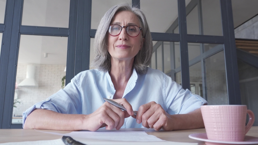 Senior older middle aged business woman online teacher, remote tutor, distance coach, executive talking to camera in virtual webinar, web conference video call chat working at home office. Webcam view Royalty-Free Stock Footage #1061234485