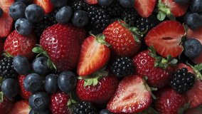 Wild forest berries on black background, collection of strawberry, blueberry and blackberry. - Powered by Shutterstock - Get 15% off with code: PIKWIZARD15