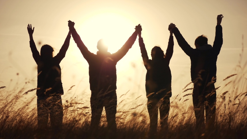 Teamwork. team community hold hands together silhouette at sunset unity. group of people hands. teamwork a workers carry out put your hands up business. team in the company working partnership | Shutterstock HD Video #1061245912