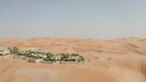 Aerial view of luxury villa with pool in Qasr Al Sarab resort in the middle of Abu Dhabi desert with sandy dunes around - Abu Dhabi, UAE - Aug 2019 