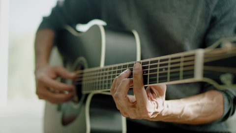 Man Hands Professionally Play Acoustic Guitar .