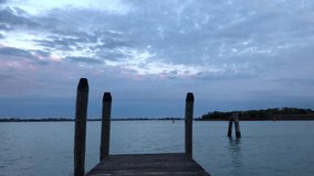 Beautiful Venetian lagoon filmed in blue hour in spring season.Popular travel destination in Metropolitan City of Venice in Italy.Royalty free 4K video clip filmed in popular travel destination