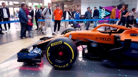 Minsk, Belarus - 27 September 2020: Demonstration show McLaren racing car bolide on display Formula1. Сrowd people with children look at and inspect racing car F1 from all sides. Editorial.
