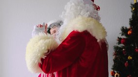 elderly santa claus with white beard dancing dance with his wife, concept of christmas, childhood, holiday mood, congratulations, good wishes - Powered by Shutterstock - Get 15% off with code: PIKWIZARD15