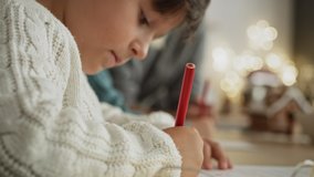 Handheld video of little boy focused on writing letter to Santa Claus. Shot with RED helium camera in 8K. - Powered by Shutterstock - Get 15% off with code: PIKWIZARD15