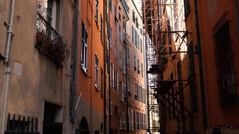 Narrow streets in Old City Port in Genova,Italy.Ancient residential buildings in Porto Antico district of Genoa,Italia.Royalty free 4K video clip filmed in popular travel destination