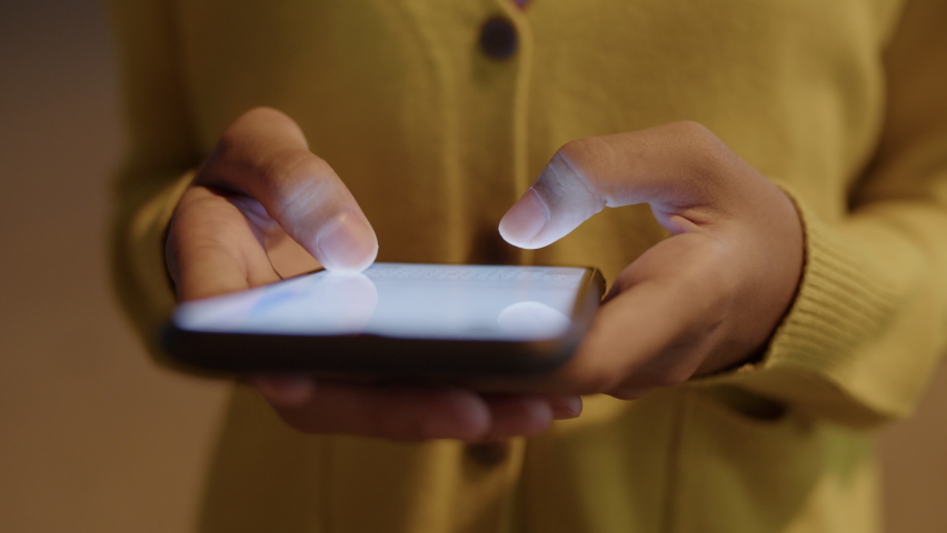 Hand of asian woman typing or chat on white screen with smartphone at night, Close up of girl hand and long sleeve yellow Royalty-Free Stock Footage #1061263819