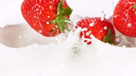 Super slow motion of strawberries falling into cream. Filmed on high speed cinema camera, 1000fps.