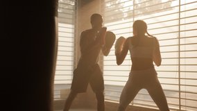 Boxing in urban gym / coach giving a Private training to a female athlete practicing a punch  - Powered by Shutterstock - Get 15% off with code: PIKWIZARD15