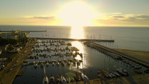 Bright Sunlight Reflection At The Calm Water Of Gdańsk Bay With Vessels Moored By The Baltic Coast In Gdynia Port City, Poland. - Aerial Drone Shot