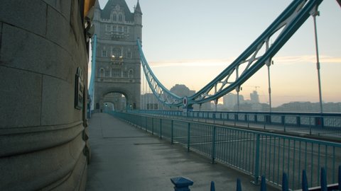 Lockdown in London, beautiful Tower Bridge completely empty during the Coronavirus pandemic 2020, in morning sunrise light.