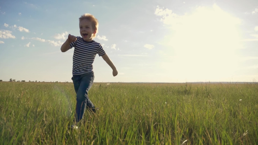 Happy child in the park. Silhouette run child at sunset. Happy child run across the field in the park. Kid is dreaming. Silhouette of a run happy kid. KId dreams of becoming an airplane pilot. Royalty-Free Stock Footage #1061281054