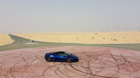 tire marks. blue Lamborghini rides through the desert. Dubai al qudra desert. 2020.08.28