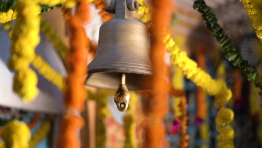Diwali Indian Festival Decoration | Hindu Temple Bell Closeup | Brass made bell is being rang by a person | Ringing bells - Selective focus Royalty-Free Stock Footage #1061283757