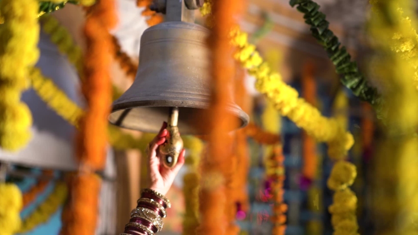 Diwali Indian Festival Decoration | Hindu Temple Bell Closeup | Brass made bell is being rang by a person | Ringing bells - Selective focus Royalty-Free Stock Footage #1061283757