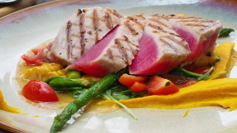delicious tuna steak with vegetables, healthy seafood, fresh medium-rare grilled tuna fish