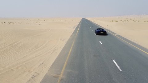 blue Lamborghini rides through the desert. Dubai al qudra desert. 2020.08.28