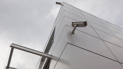 video surveillance cameras mounted on a wall of a modern building