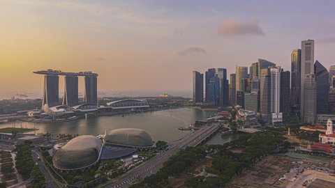 Singapore Sunset Beautiful Time lapse of day to night of Singapore city skyline from aerial and high angle overlooking Marina bay and CBD area. Pan up motion timelapse.  4K available.