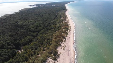 Beautiful aerial drone wide view of Curonian spit. Kurshskaya Kosa National Park. Curonian Lagoon and the Baltic Sea, Kaliningrad Oblast, Russia and Klaipeda County. Lithuania, summer day.
