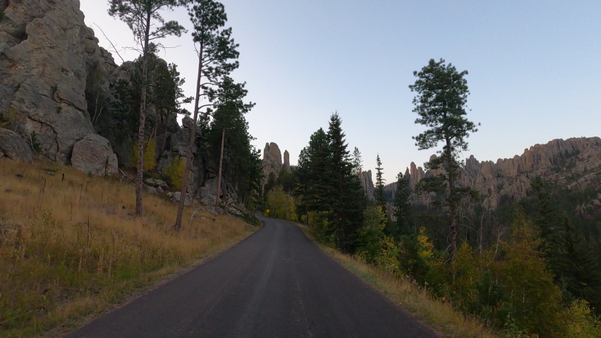 Black Hills Needles Custer South Dakota sunset drive POV fast motion. Black Hills of South Dakota. Mountain, valley, landscape scenic discovery. State Park with wildlife, lakes, campgrounds and picnic